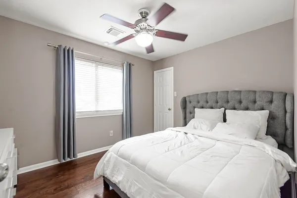 a bedroom with a large bed and a window