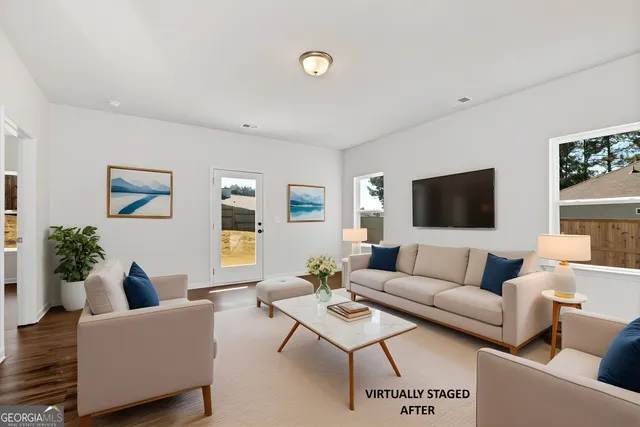 a living room with furniture and a flat screen tv