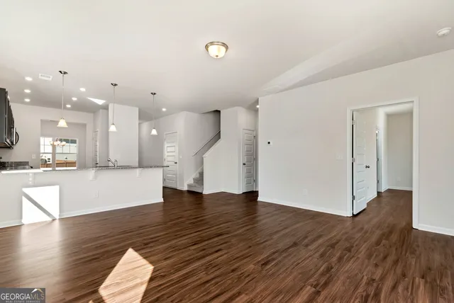 a view of kitchen and hall with wooden floor