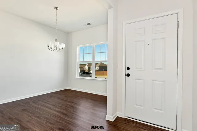 a view of a room with wooden floor and window