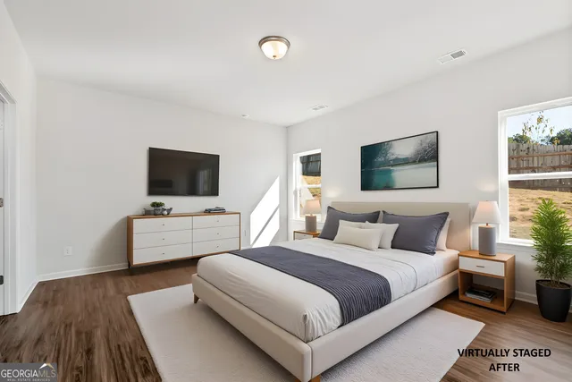 a bedroom with a bed and a flat screen tv