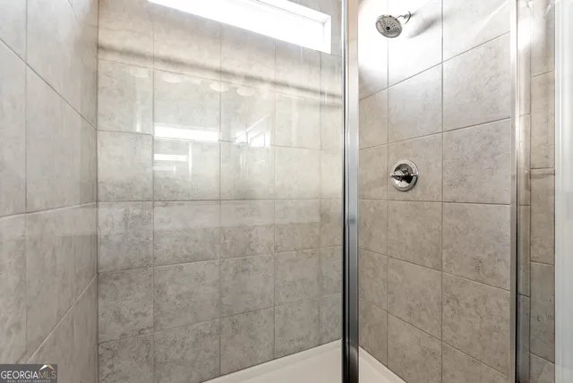 a bathroom with a glass shower door