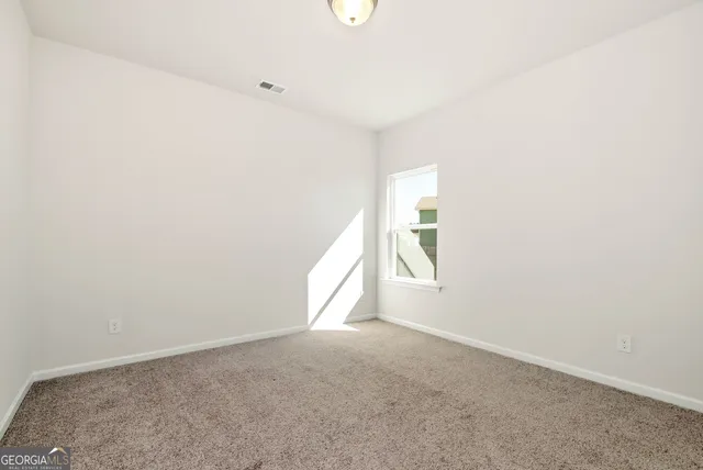 an empty room with closet area