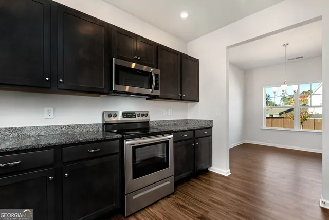 a kitchen with stainless steel appliances wooden cabinets and a stove top oven