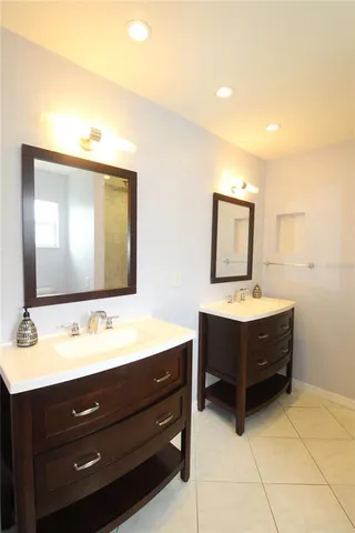 a bathroom with a sink a mirror and a bathtub