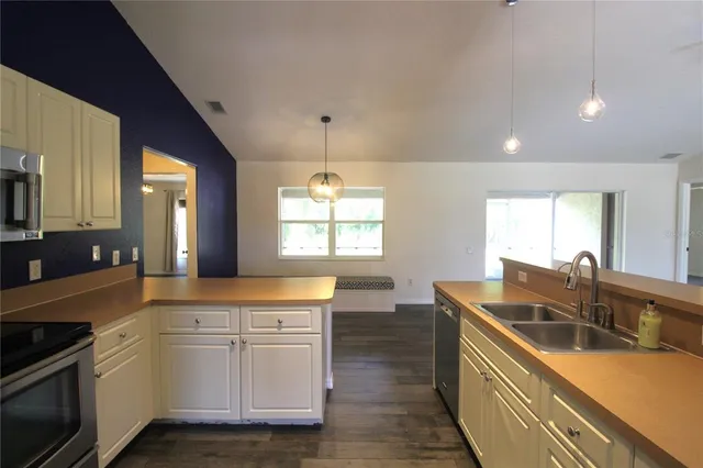 a kitchen that has a sink and a stove