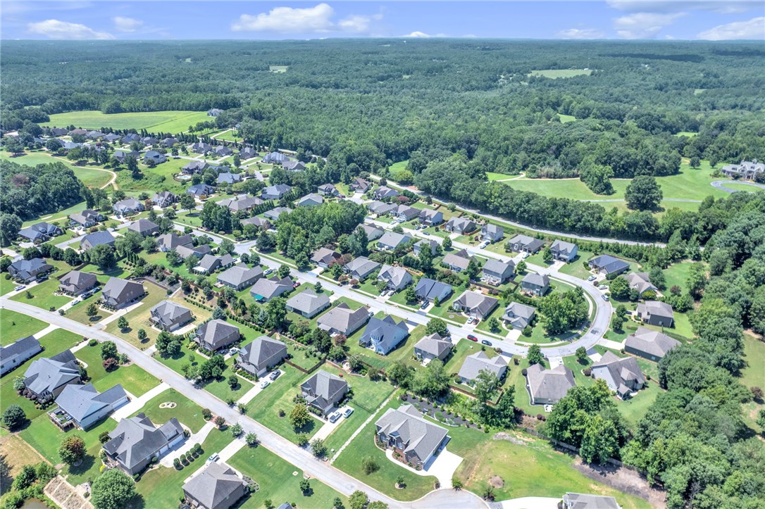 116 Stone Cottage Drive Anderson, SC 29621 - Photo 41 of 43 An aerial perspective showcases a manicured neighborhood bordered by dense green forests.