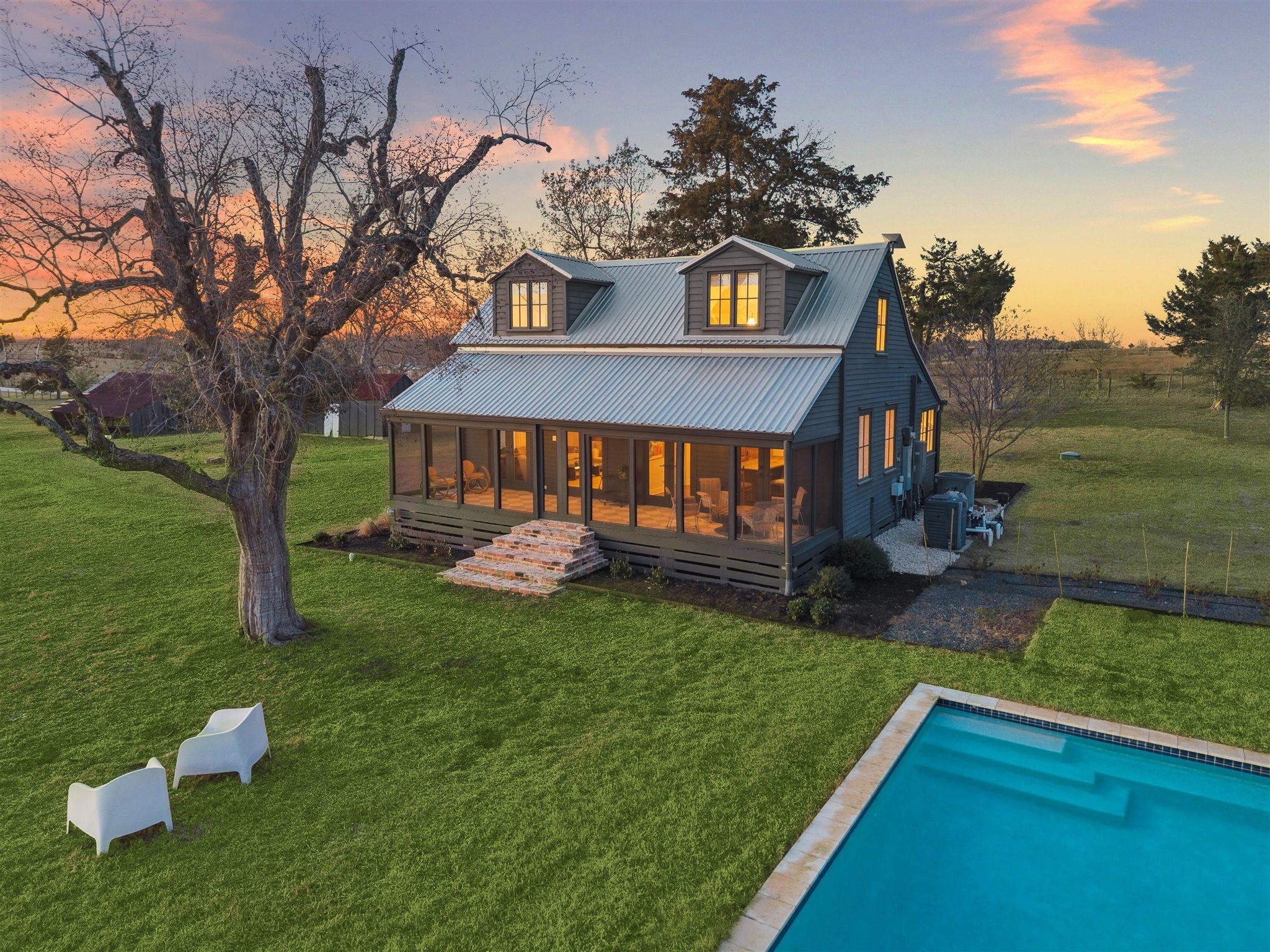 6389 Miller Road New Ulm, TX 78950 - Photo 1 of 49 a front view of a house with a garden