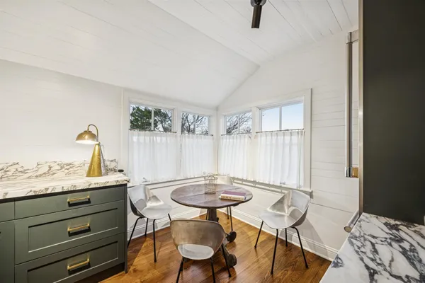 a view of a workspace with furniture and a window