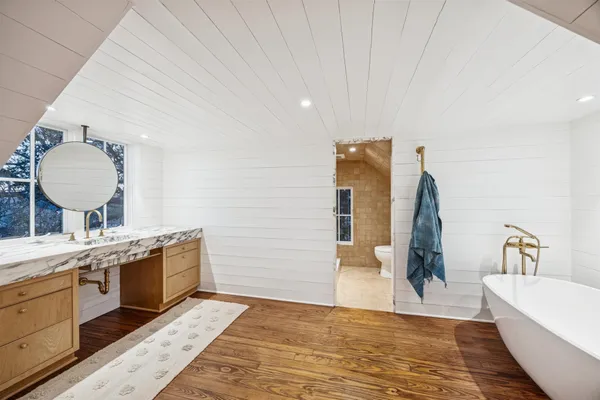 a spacious bathroom with a double vanity sink and a mirror