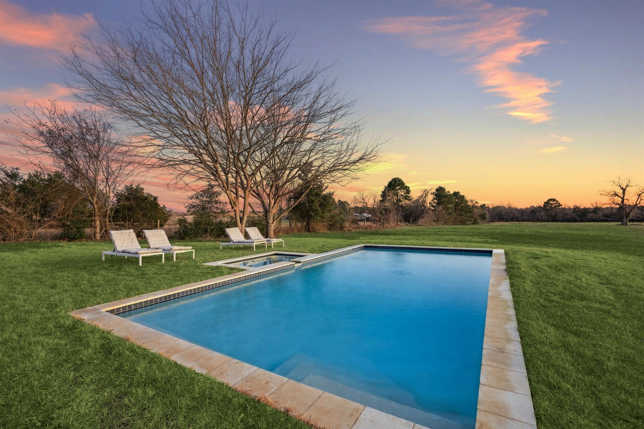 6389 Miller Road New Ulm, TX 78950 - Photo 25 of 49 a view of a swimming pool and trees in the background