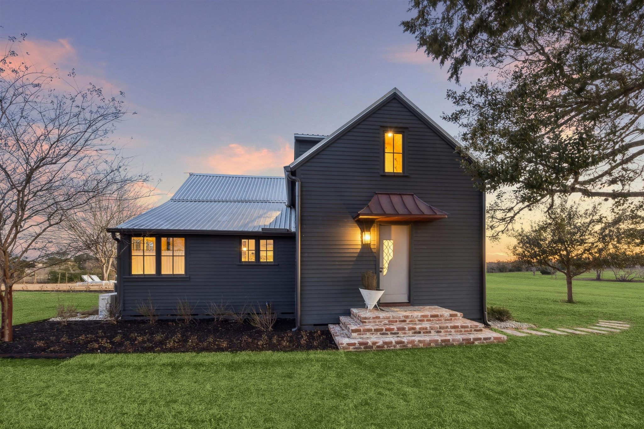 6389 Miller Road New Ulm, TX 78950 - Photo 3 of 49 a front view of a house with garden