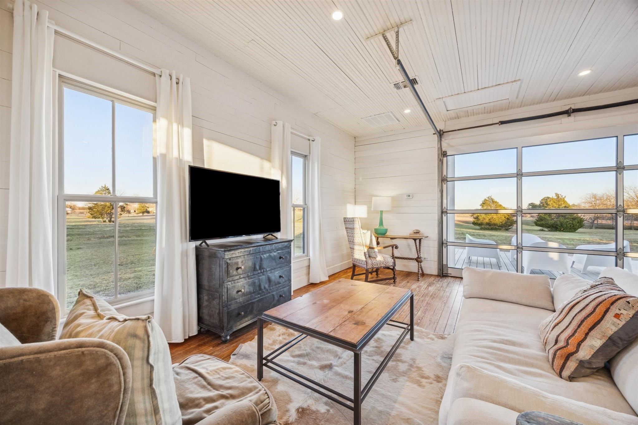 6389 Miller Road New Ulm, TX 78950 - Photo 32 of 49 a living room with furniture a flat screen tv and a large window