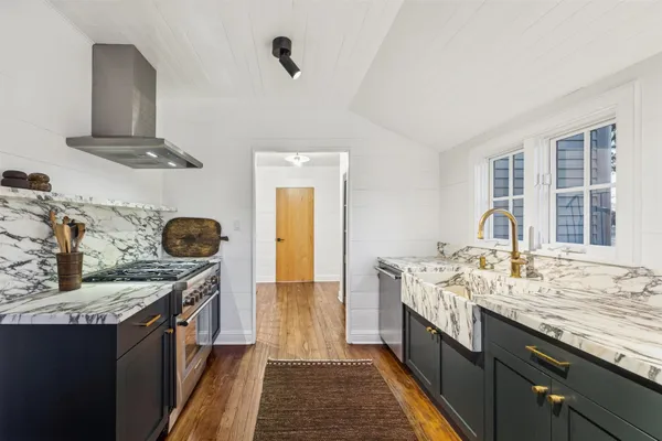 a kitchen with granite countertop a sink and a stove
