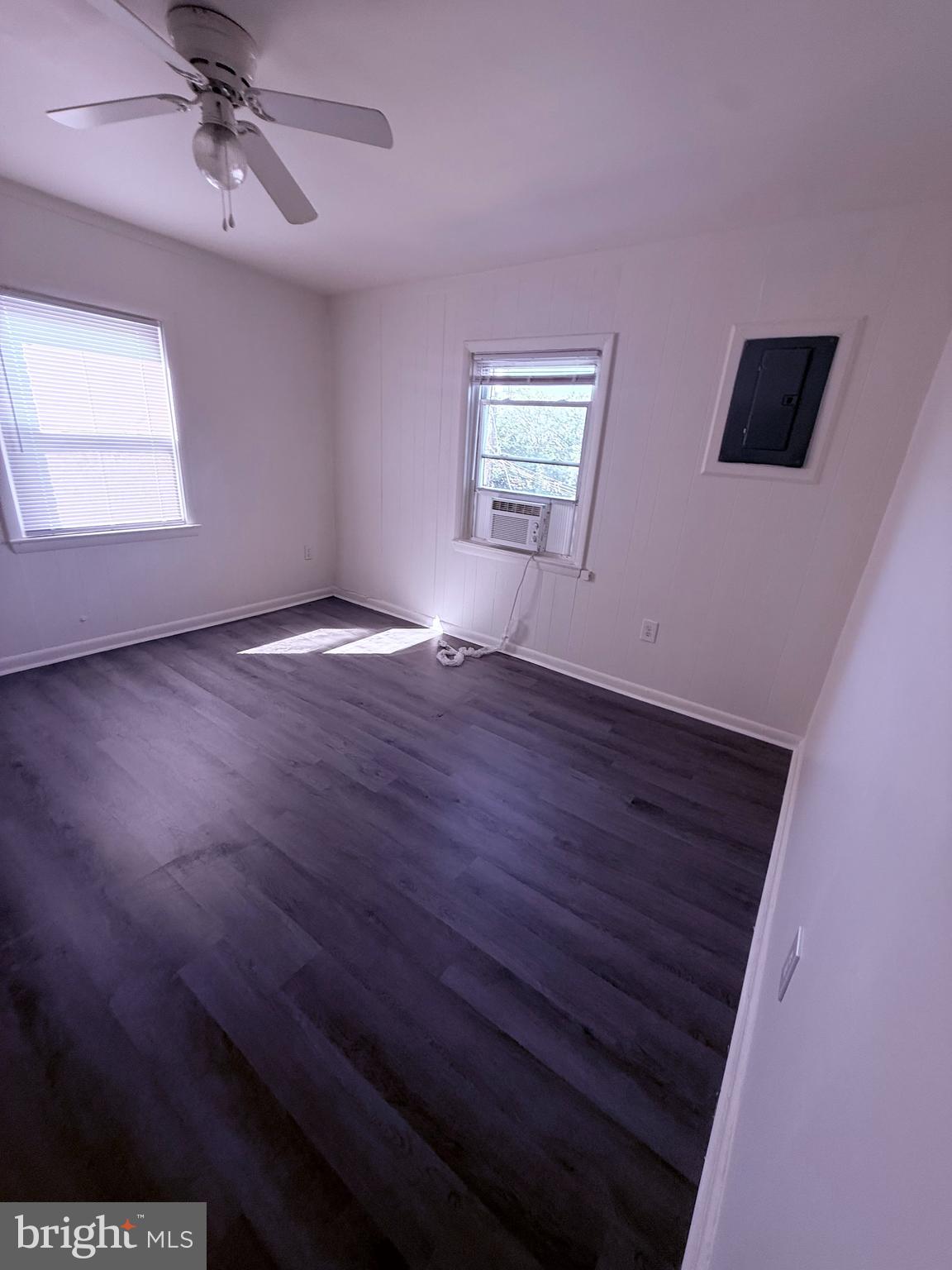 520 Baltic Avenue, Unit B Brooklyn, MD 21225 - Photo 10 of 11 a view of empty room with wooden floor and fan