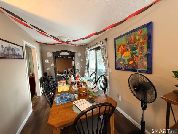 a view of a dining room with furniture and chandelier