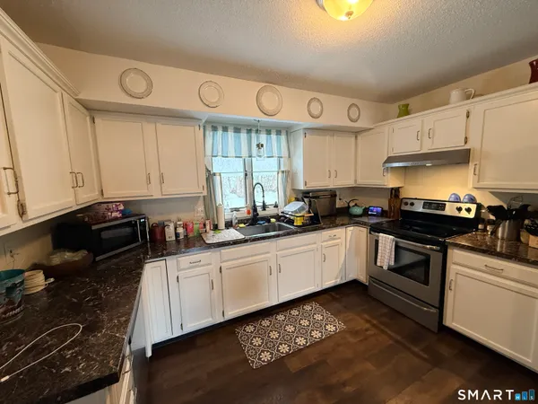 a kitchen with a sink stove and cabinets