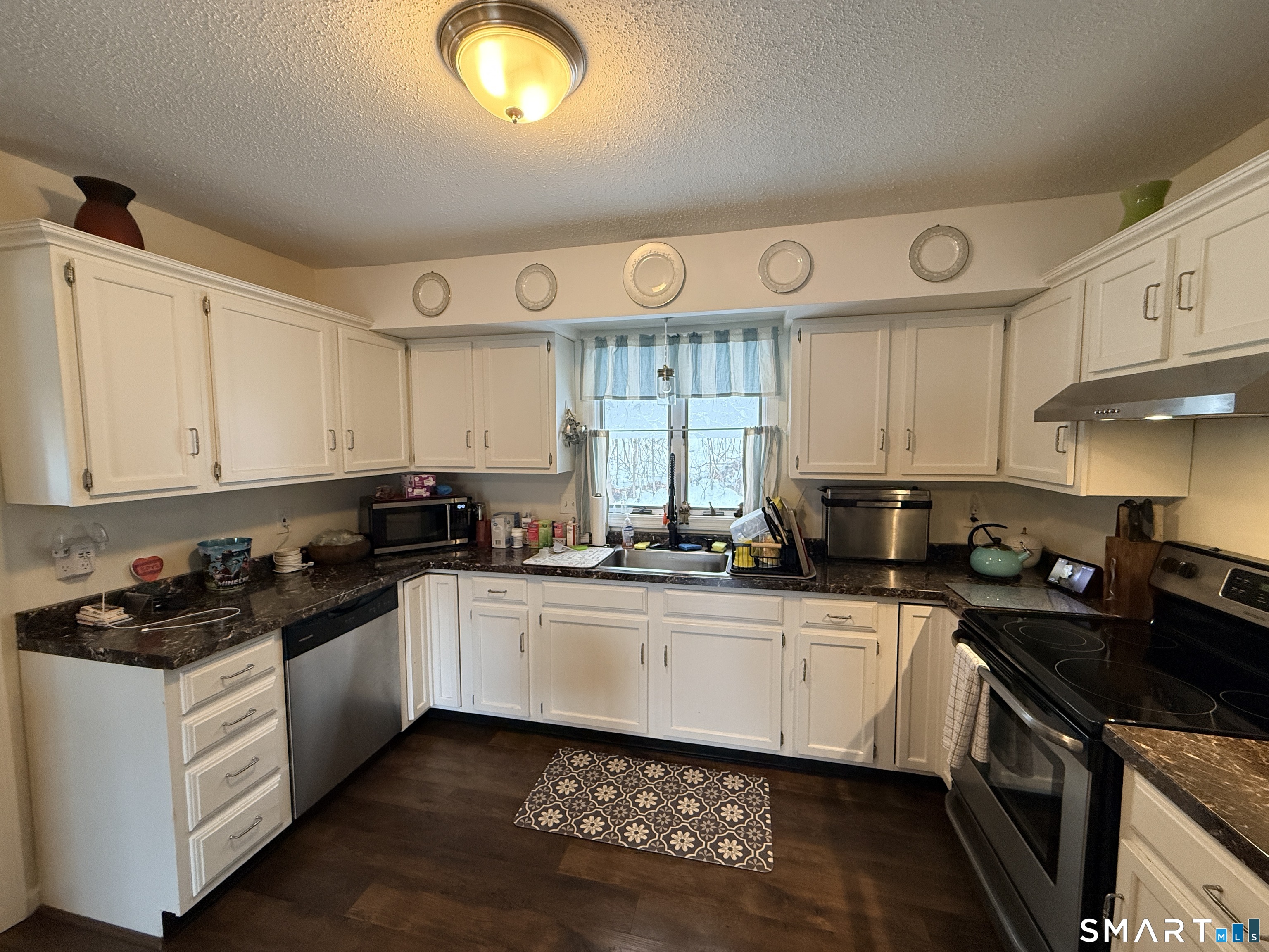 44 Lewis Street Winchester, CT 06098 - Photo 17 of 25 a kitchen with a sink a stove and cabinets