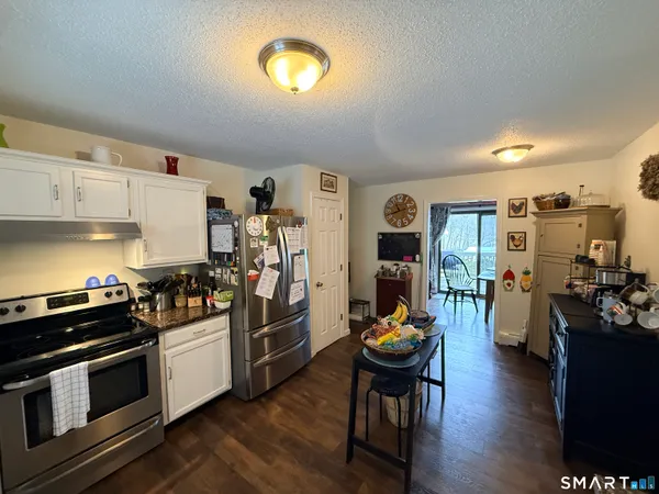 a kitchen with stainless steel appliances a stove a sink dishwasher and cabinets with wooden floor