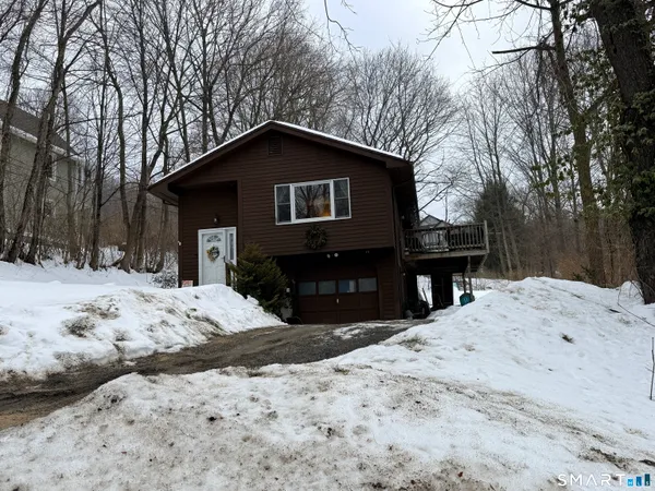 a house covered in snow in front of house