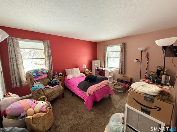 a bedroom with bed and a window