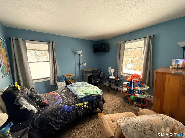 a bedroom with bed and a window