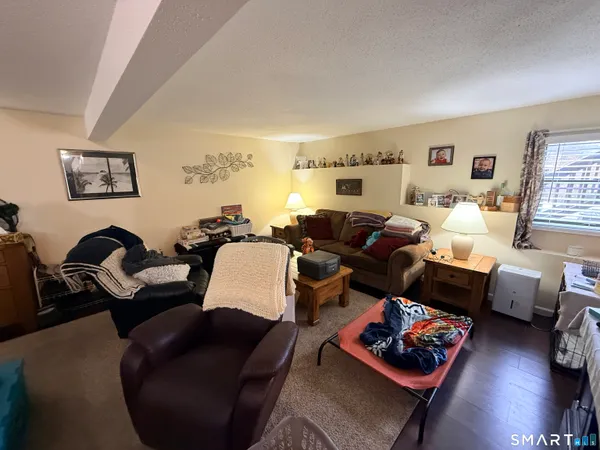 a living room with furniture lamp and window