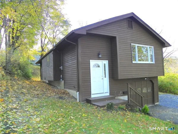 a front view of house with a garden