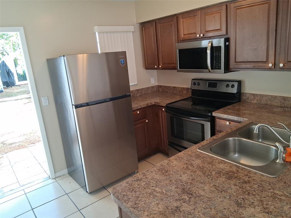 6710 121st Avenue, Unit 10 Largo, FL 33773 - Photo 3 of 17 a kitchen with a refrigerator sink and microwave