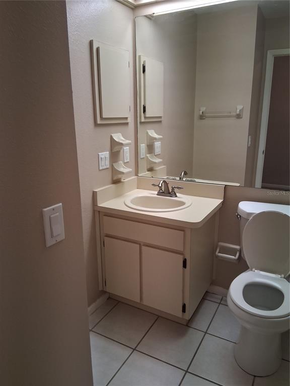 6710 121st Avenue, Unit 10 Largo, FL 33773 - Photo 8 of 17 a bathroom with a toilet sink and mirror