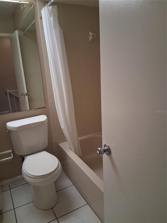 6710 121st Avenue, Unit 10 Largo, FL 33773 - Photo 9 of 17 a white toilet sitting next to a bath tub