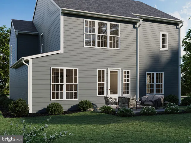 a front view of a house with a garden and yard