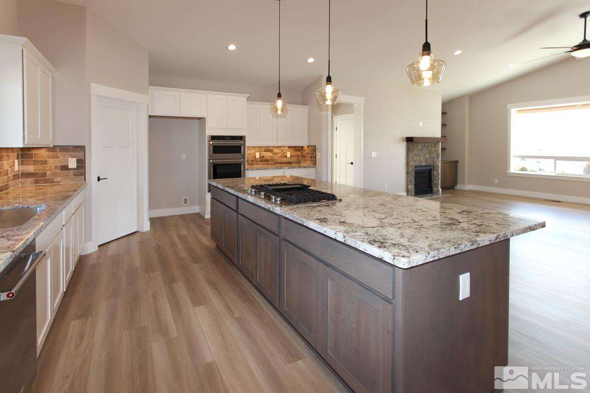 5077 Conte Drive Carson City, NV 89701 - Photo 13 of 40 a kitchen with stainless steel appliances granite countertop a sink stove and a refrigerator