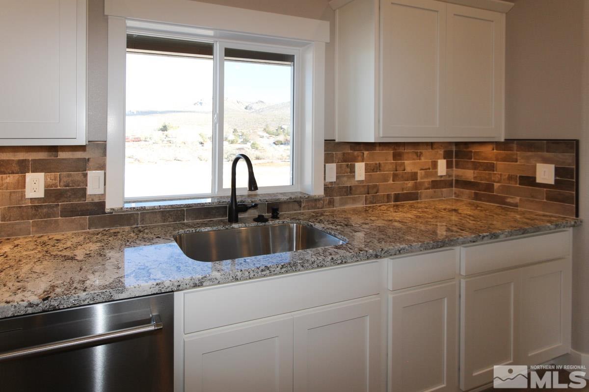 5077 Conte Drive Carson City, NV 89701 - Photo 15 of 40 a kitchen with granite countertop a sink and a window