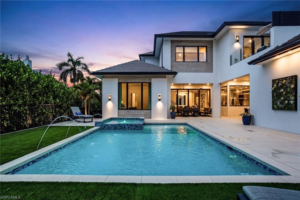 a view of a house with swimming pool and sitting area
