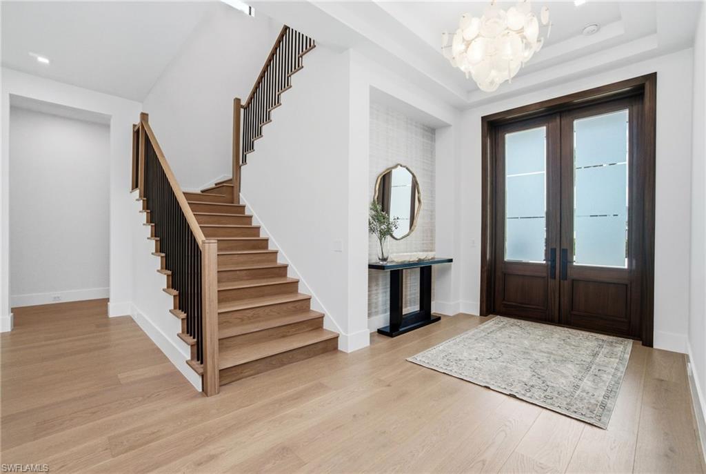 264 8th Avenue South Naples, FL 34102 - Photo 18 of 40 a view of entryway and hall with wooden floor