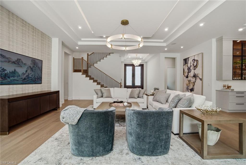 264 8th Avenue South Naples, FL 34102 - Photo 2 of 40 a living room with fireplace furniture and a flat screen tv