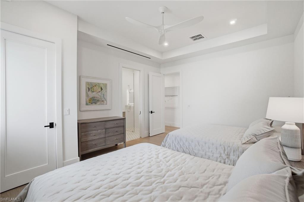 264 8th Avenue South Naples, FL 34102 - Photo 22 of 40 a bedroom with a bed and a painting on the wall