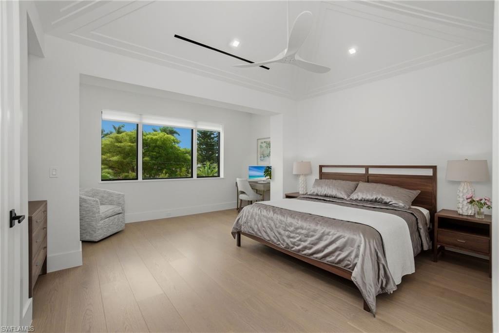 264 8th Avenue South Naples, FL 34102 - Photo 24 of 40 a bed sitting in a spacious bedroom next to a window