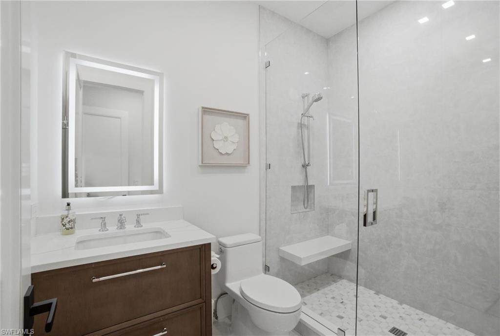 264 8th Avenue South Naples, FL 34102 - Photo 25 of 40 a bathroom with a sink a toilet and shower