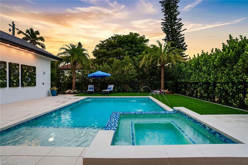 264 8th Avenue South Naples, FL 34102 - Photo 29 of 40 a view of a swimming pool with a yard and plants