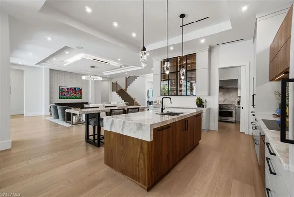 a large kitchen with stainless steel appliances lots of counter space and windows