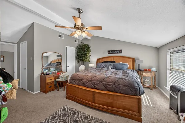 a bedroom with a bed couch and window