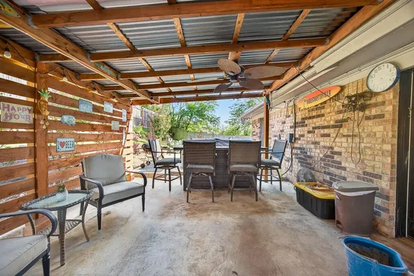 a building outdoor space with patio furniture and potted plants