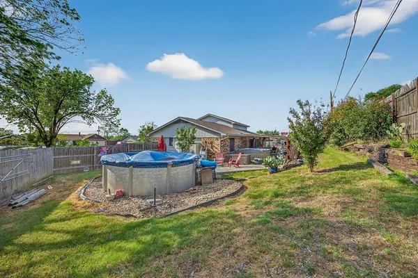 a view of a backyard with plants and a patio
