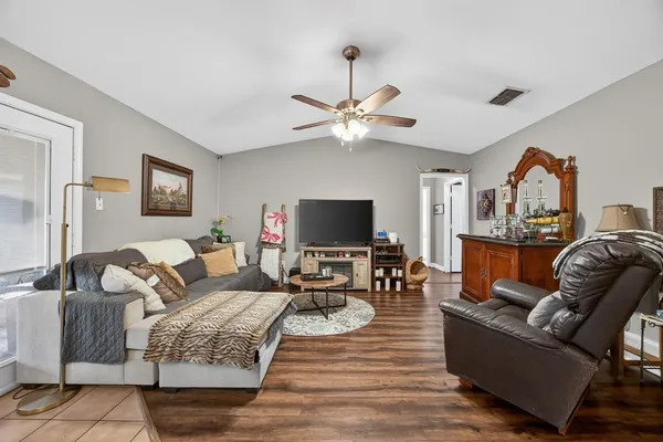 a living room with furniture fireplace and a flat screen tv