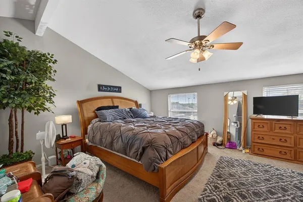 a bedroom with a bed and ceiling fan