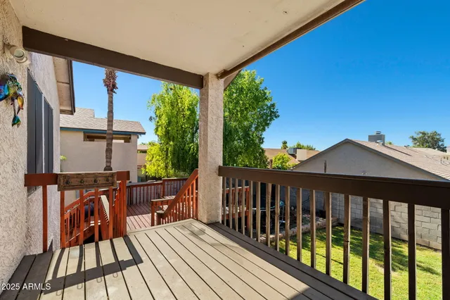 a view of a swimming pool with a patio and a yard