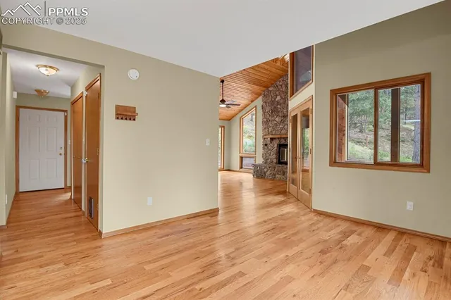 a view of a kitchen with furniture cabinet and a ceiling fan