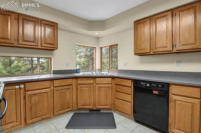 a kitchen with stainless steel appliances granite countertop a refrigerator and a stove